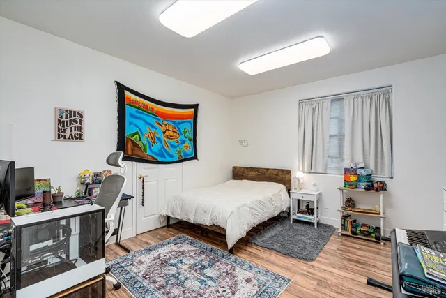 a bedroom with a bed and a window