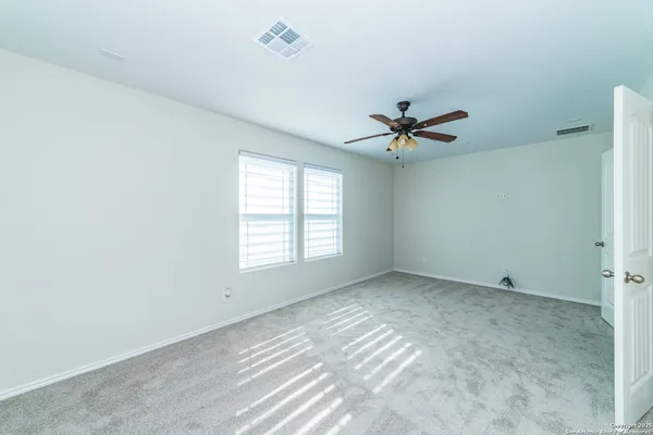 a view of a room with air conditioner and ceiling fan