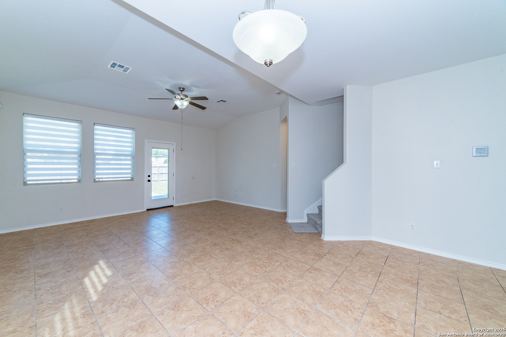 7735 Brisbane Bend Converse, TX 78109 - Photo 4 of 15 an empty room with windows and fan