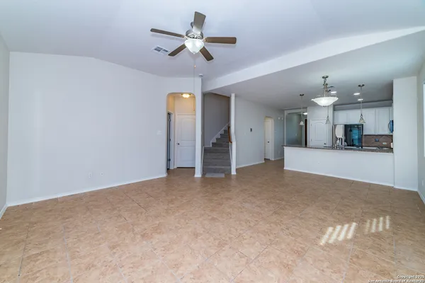 a view of a kitchen with a sink and a ceiling fan