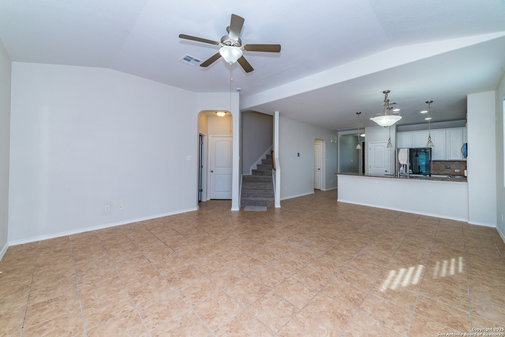 7735 Brisbane Bend Converse, TX 78109 - Photo 5 of 15 a view of a kitchen with a sink and a ceiling fan