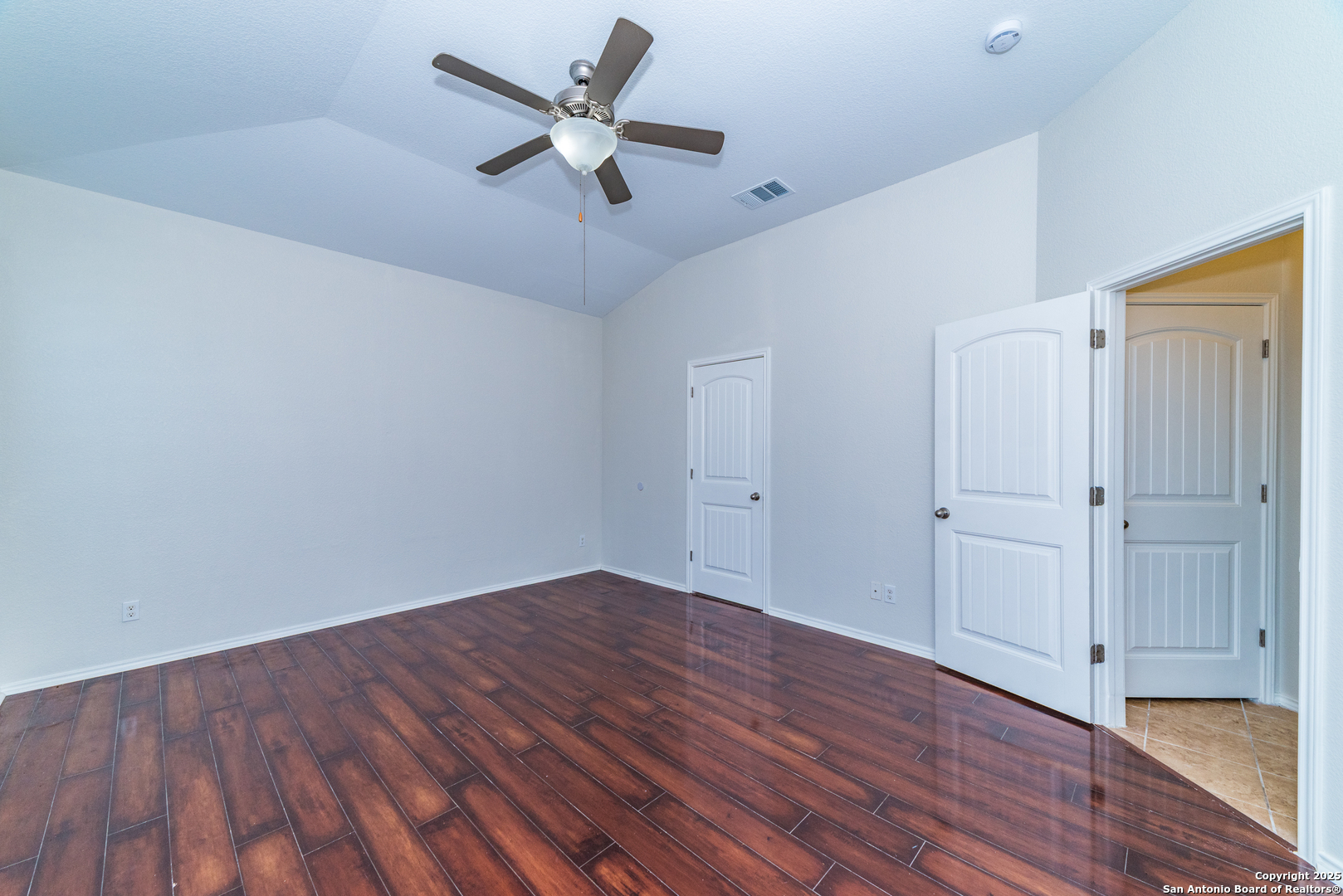 7735 Brisbane Bend Converse, TX 78109 - Photo 6 of 15 an empty room with wooden floor and windows