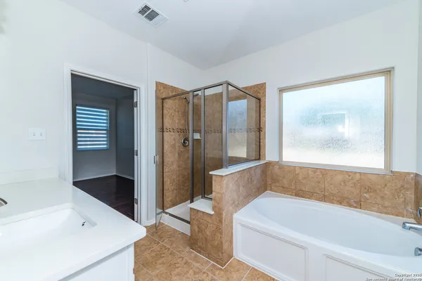 a bathroom with a bathtub and a shower