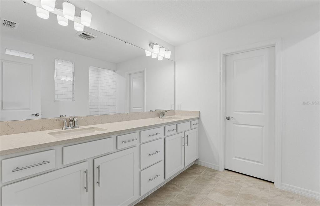 1691 Ruby Ln Lake Lake Alfred, FL 33850 - Photo 14 of 34 a spacious bathroom with a double vanity sink and a mirror