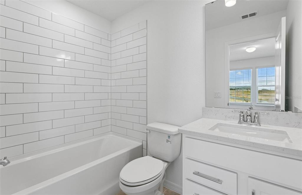 1691 Ruby Ln Lake Lake Alfred, FL 33850 - Photo 20 of 34 a bathroom with a sink a toilet and bathtub