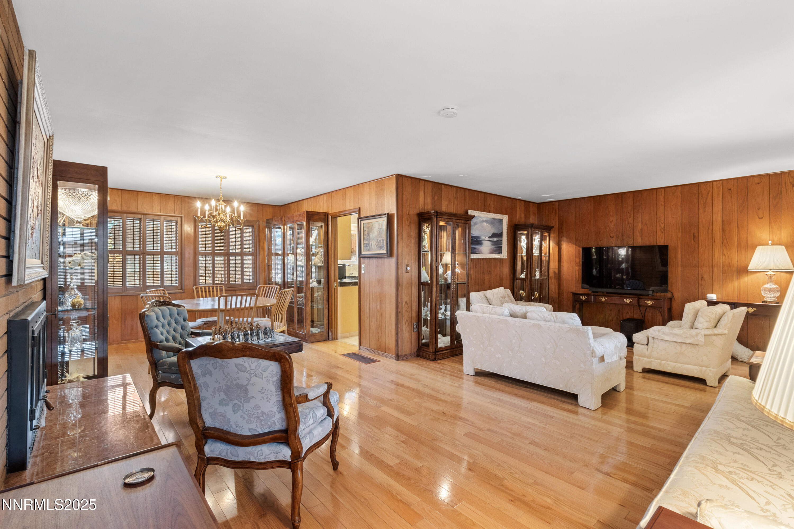 1885 Solari Drive Reno, NV 89509 - Photo 15 of 52 a living room with furniture a flat screen tv and a floor to ceiling window