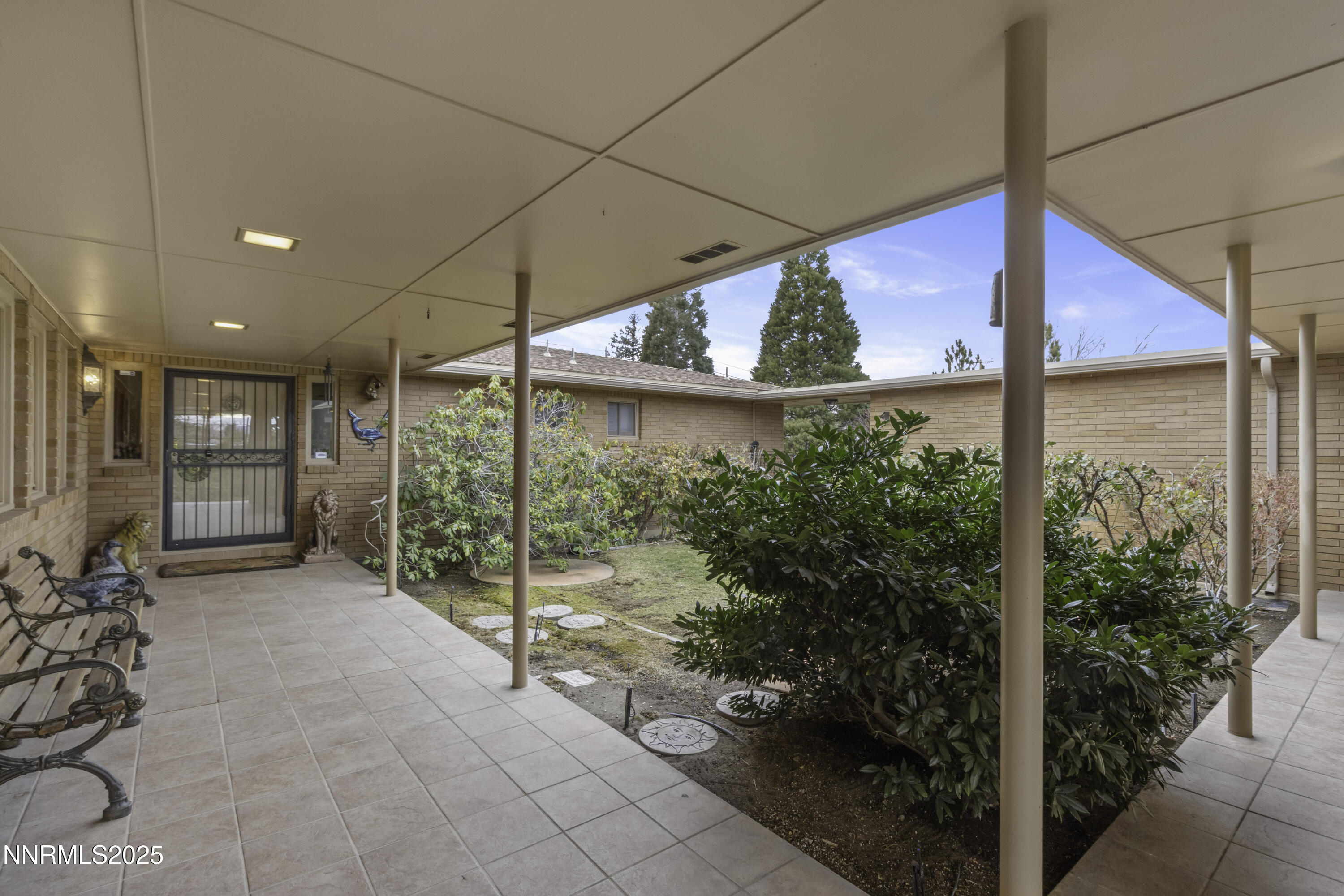 1885 Solari Drive Reno, NV 89509 - Photo 2 of 52 a view of a porch with a table and chairs and potted plants