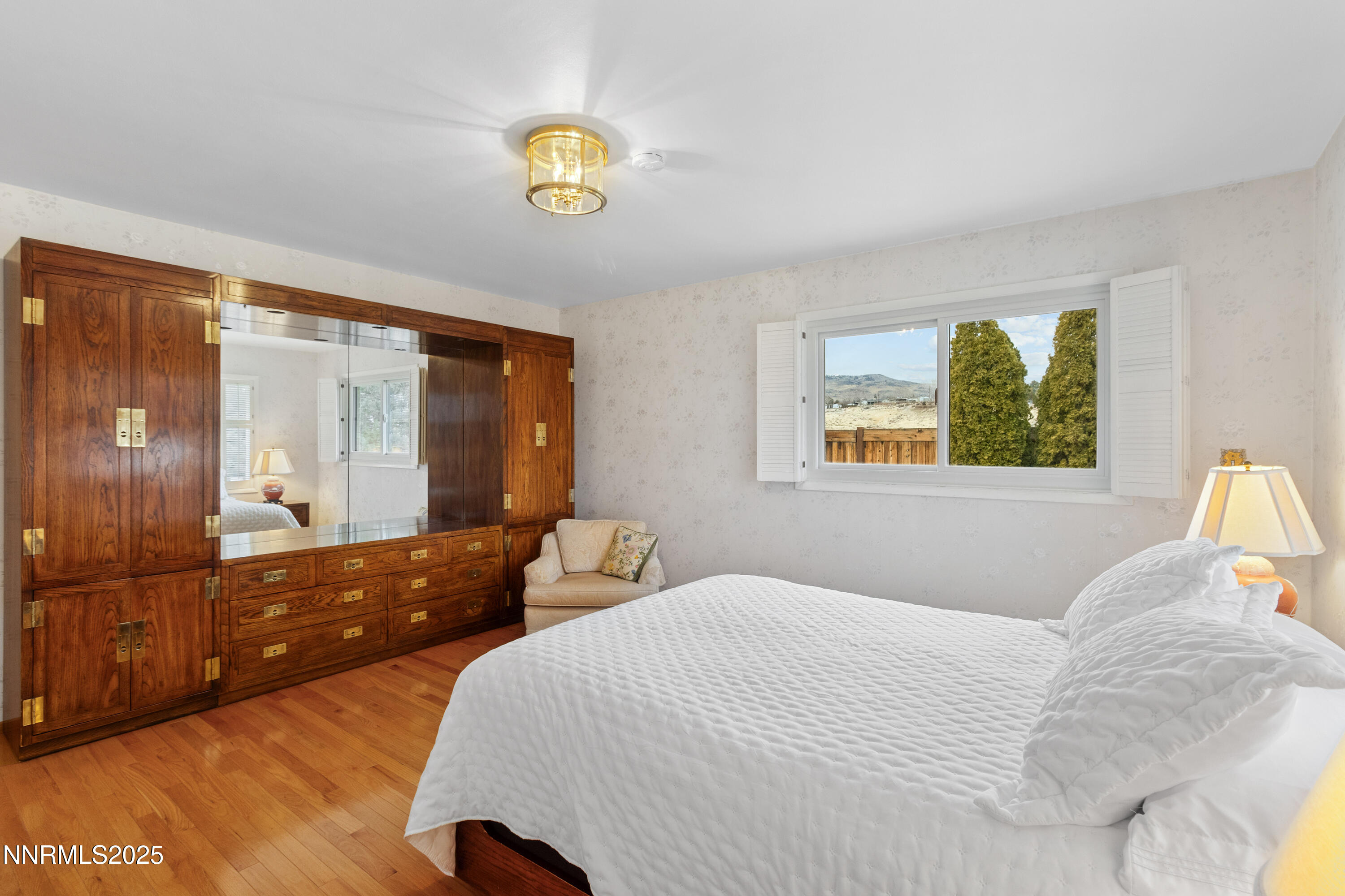 1885 Solari Drive Reno, NV 89509 - Photo 22 of 52 a bedroom with a bed and wooden floor