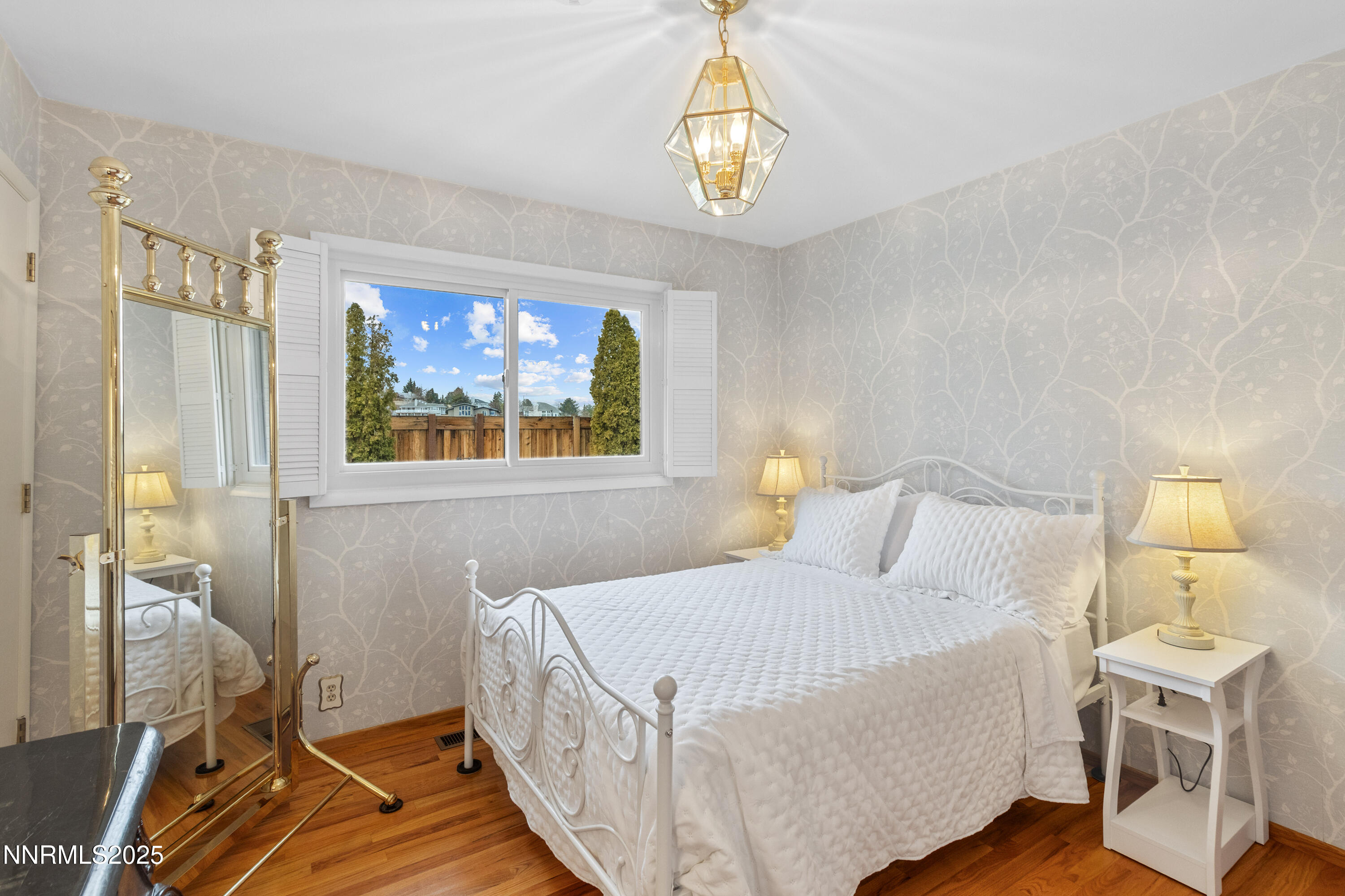 1885 Solari Drive Reno, NV 89509 - Photo 25 of 52 a bedroom with a bed and a chandelier