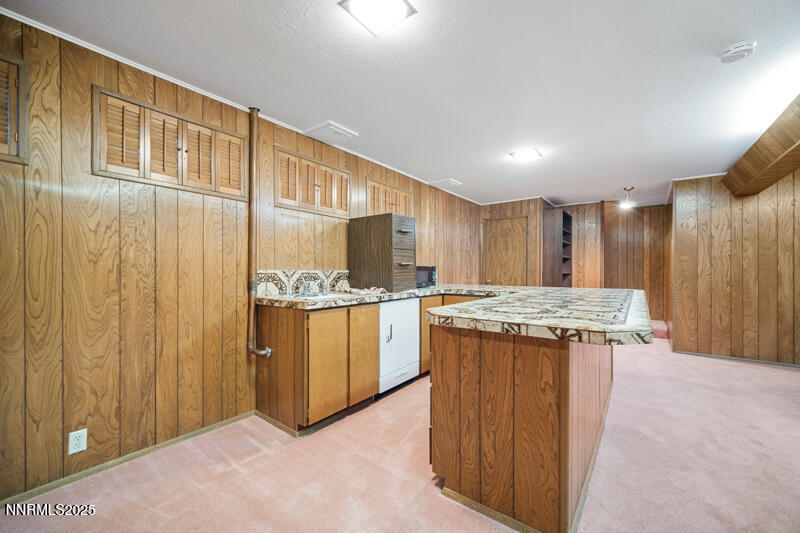 1885 Solari Drive Reno, NV 89509 - Photo 50 of 52 a kitchen with kitchen island granite countertop wooden cabinets and white appliances
