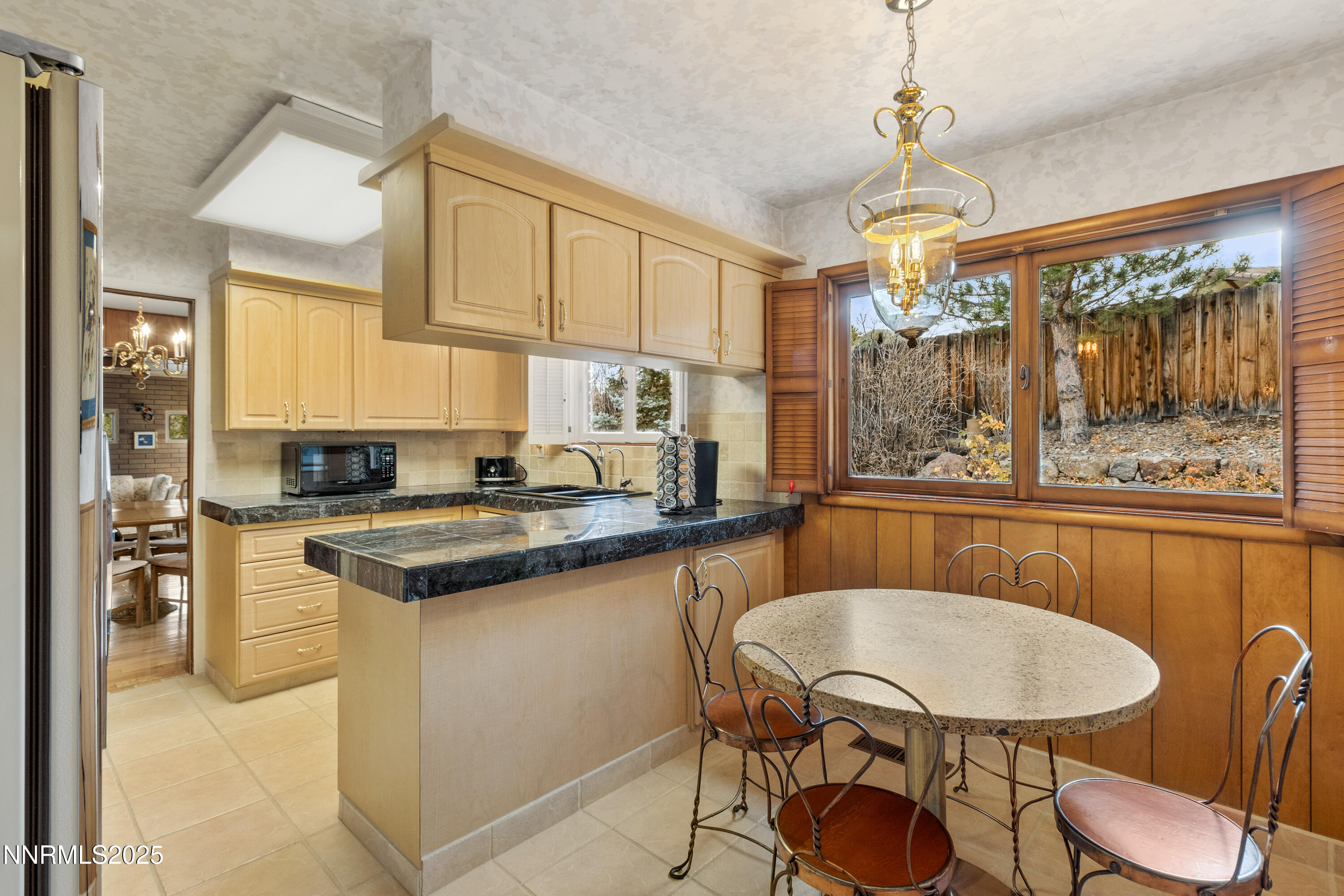 1885 Solari Drive Reno, NV 89509 - Photo 8 of 52 a kitchen with a table chairs stove and cabinets