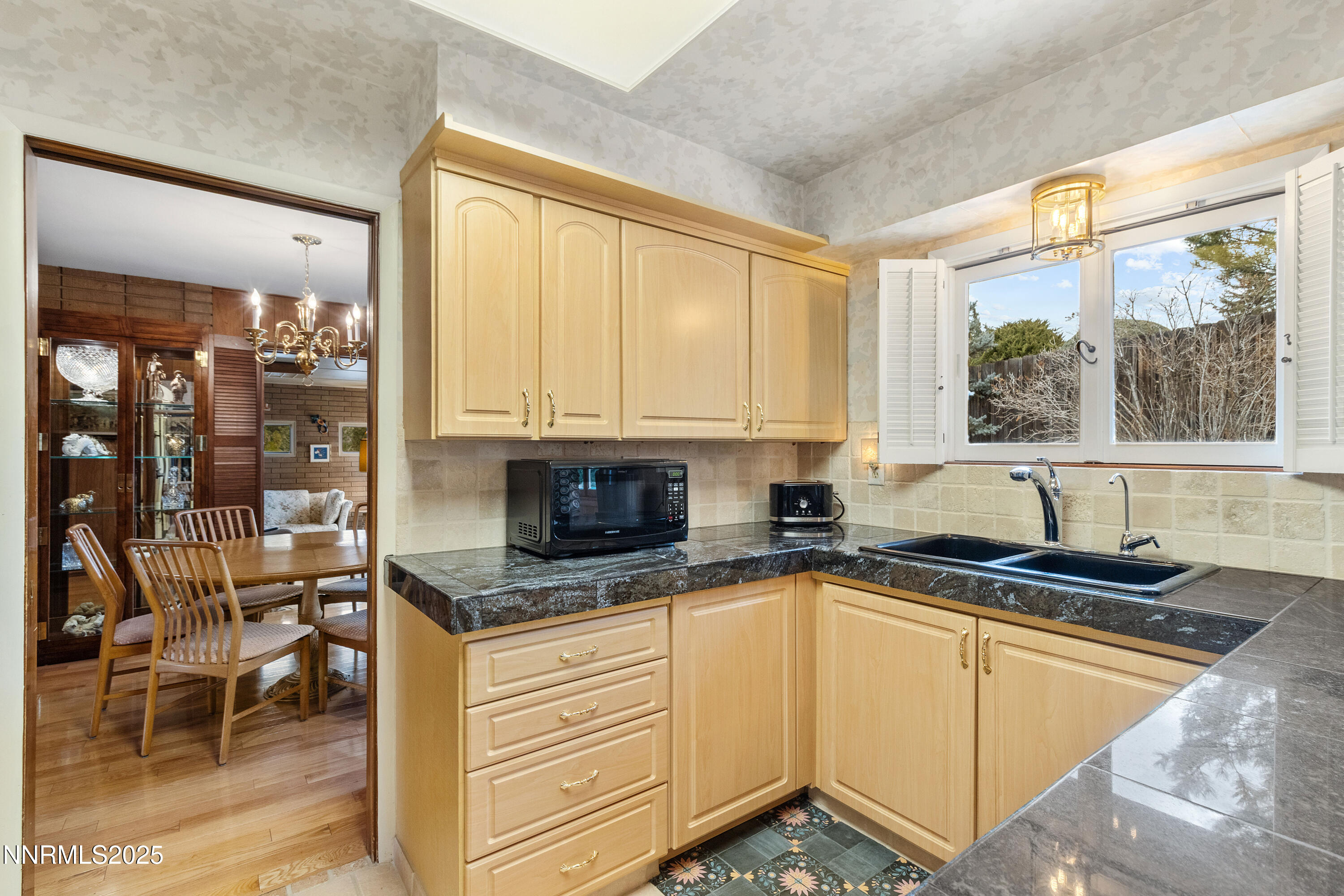 1885 Solari Drive Reno, NV 89509 - Photo 9 of 52 a kitchen with granite countertop a stove a sink and a counter space