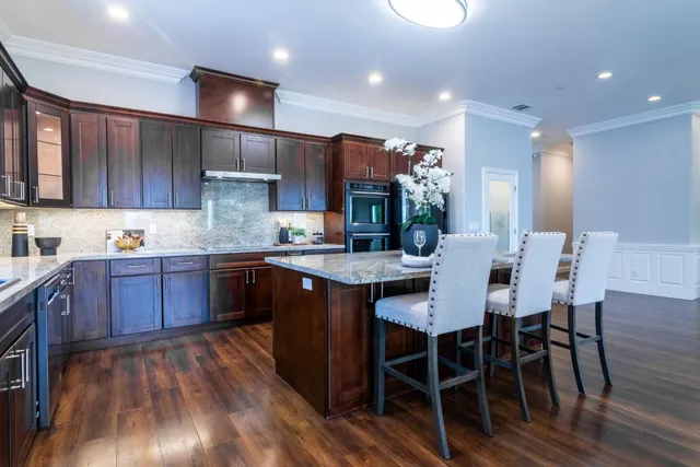 a living room with lots of furniture and kitchen view