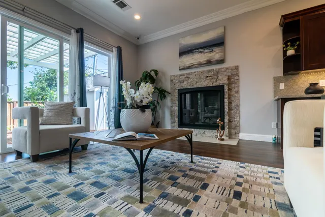 an empty room with wooden floor mirror and windows