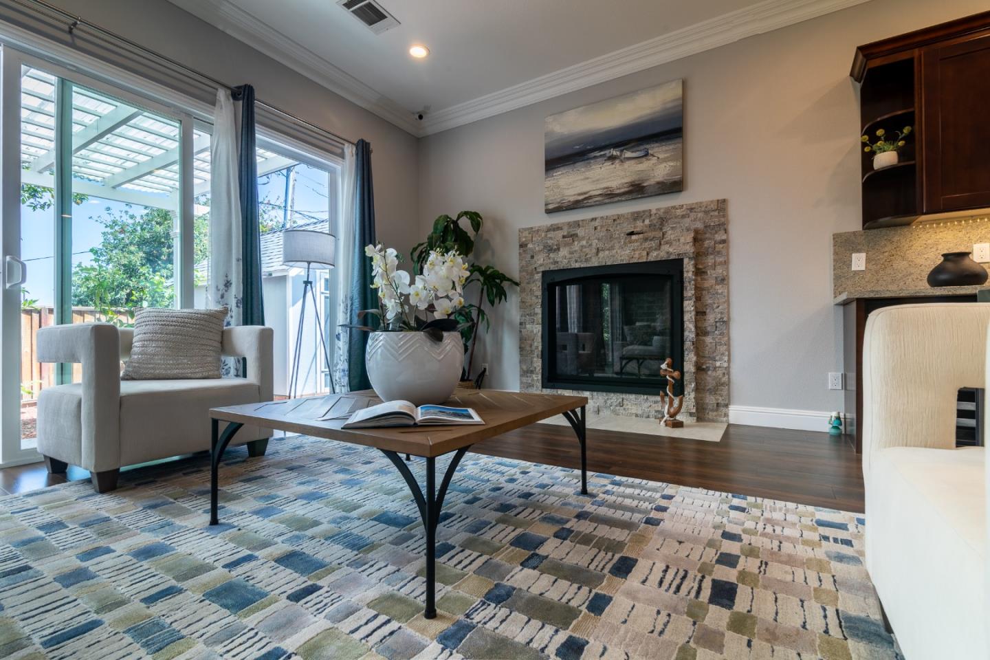 1258 South Stelling Road Cupertino, CA 95014 - Photo 20 of 56 a living room with furniture a fireplace and a floor to ceiling window