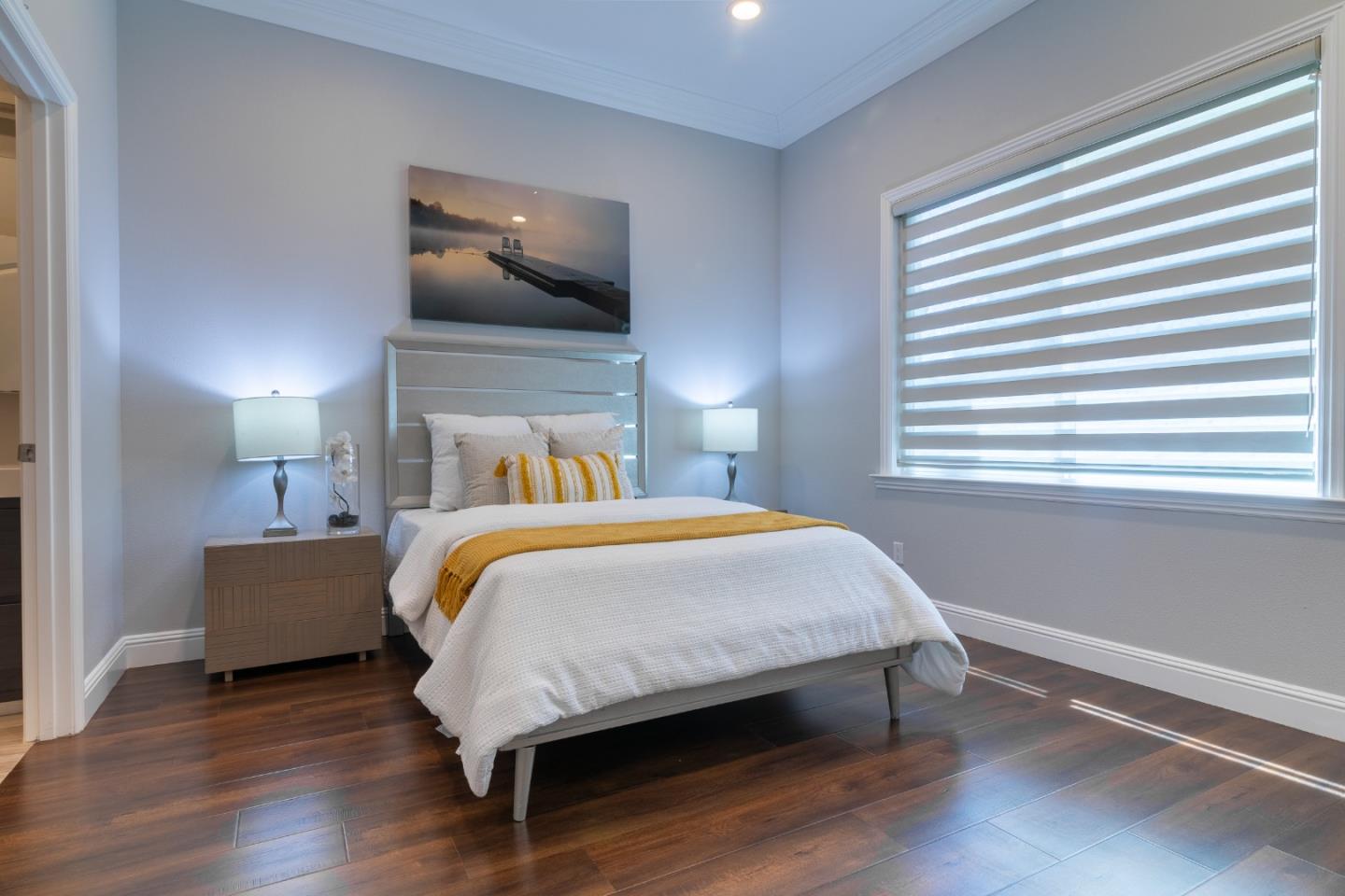 1258 South Stelling Road Cupertino, CA 95014 - Photo 41 of 56 a bed sitting in a bedroom next to a window and a chandelier