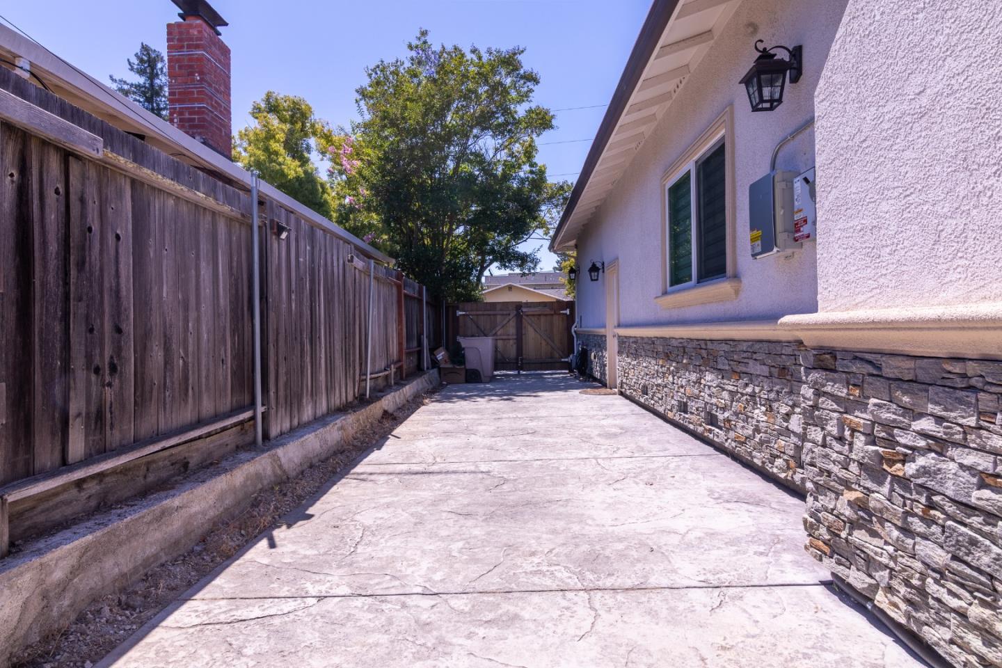1258 South Stelling Road Cupertino, CA 95014 - Photo 46 of 56 a pathway of a house with a small yard and wooden fence