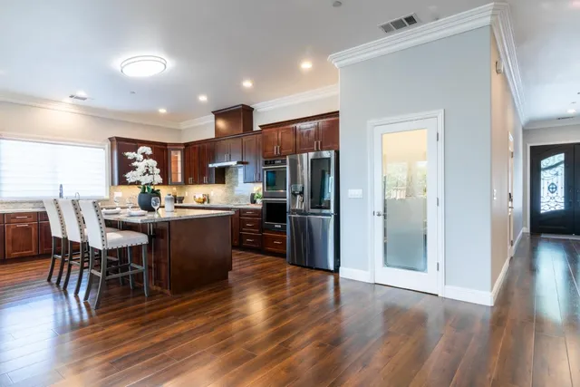 a kitchen with sink cabinets and stainless steel appliances
