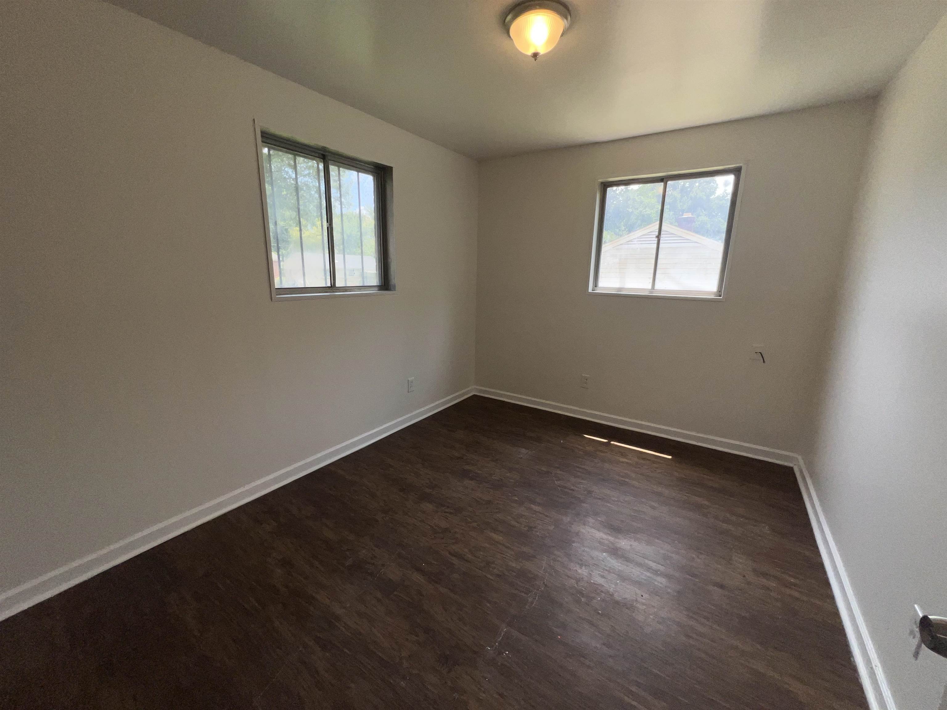 2235 Charjean Road Memphis, TN 38114 - Photo 11 of 15 a view of an empty room with wooden floor and a window
