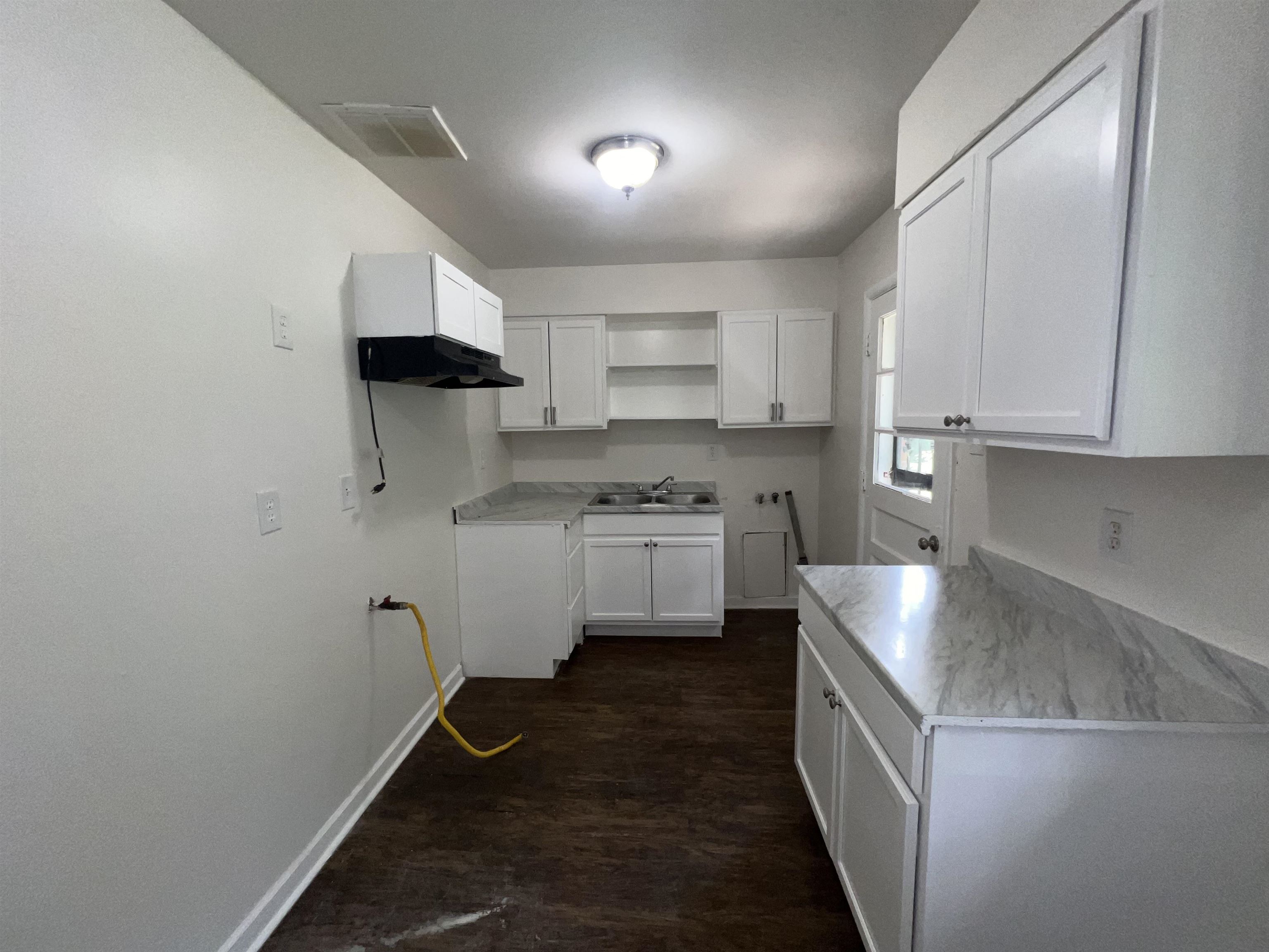 2235 Charjean Road Memphis, TN 38114 - Photo 4 of 15 a kitchen with a sink a stove and cabinets