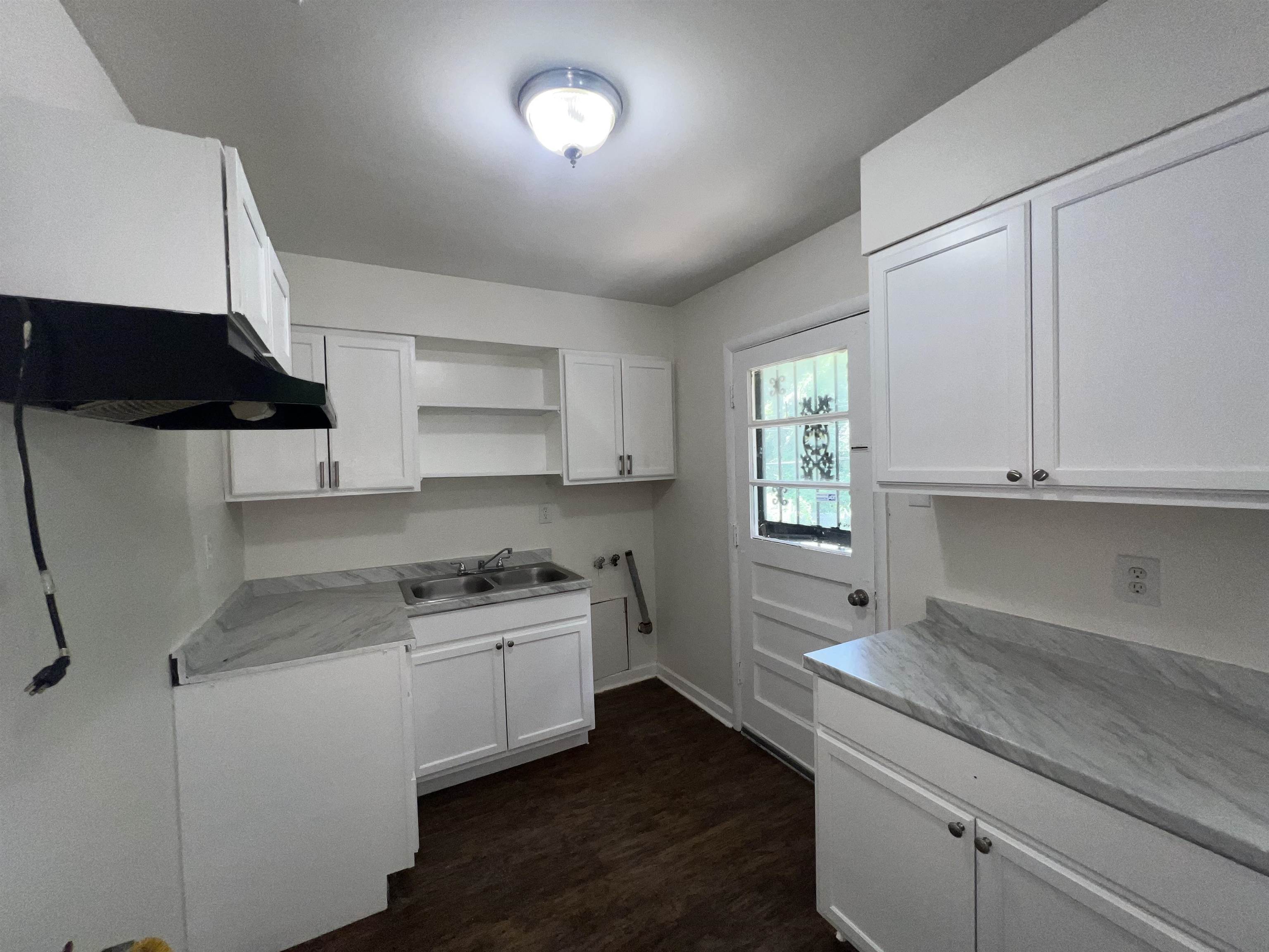 2235 Charjean Road Memphis, TN 38114 - Photo 5 of 15 a kitchen with a sink stove and cabinets