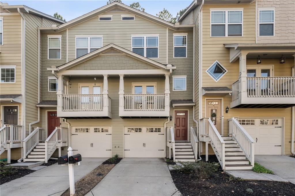 1096 Liberty Parkway Northwest Atlanta, GA 30318 - Photo 1 of 22 a front view of a house with large windows