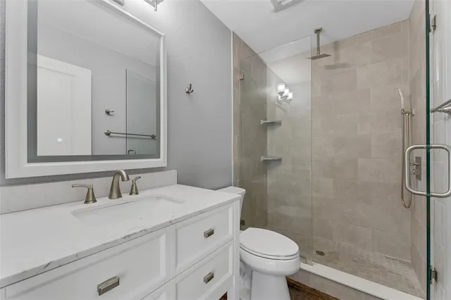 a bathroom with a sink toilet and shower