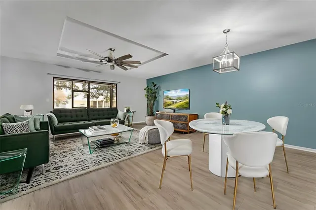 a living room with furniture a chandelier and a window