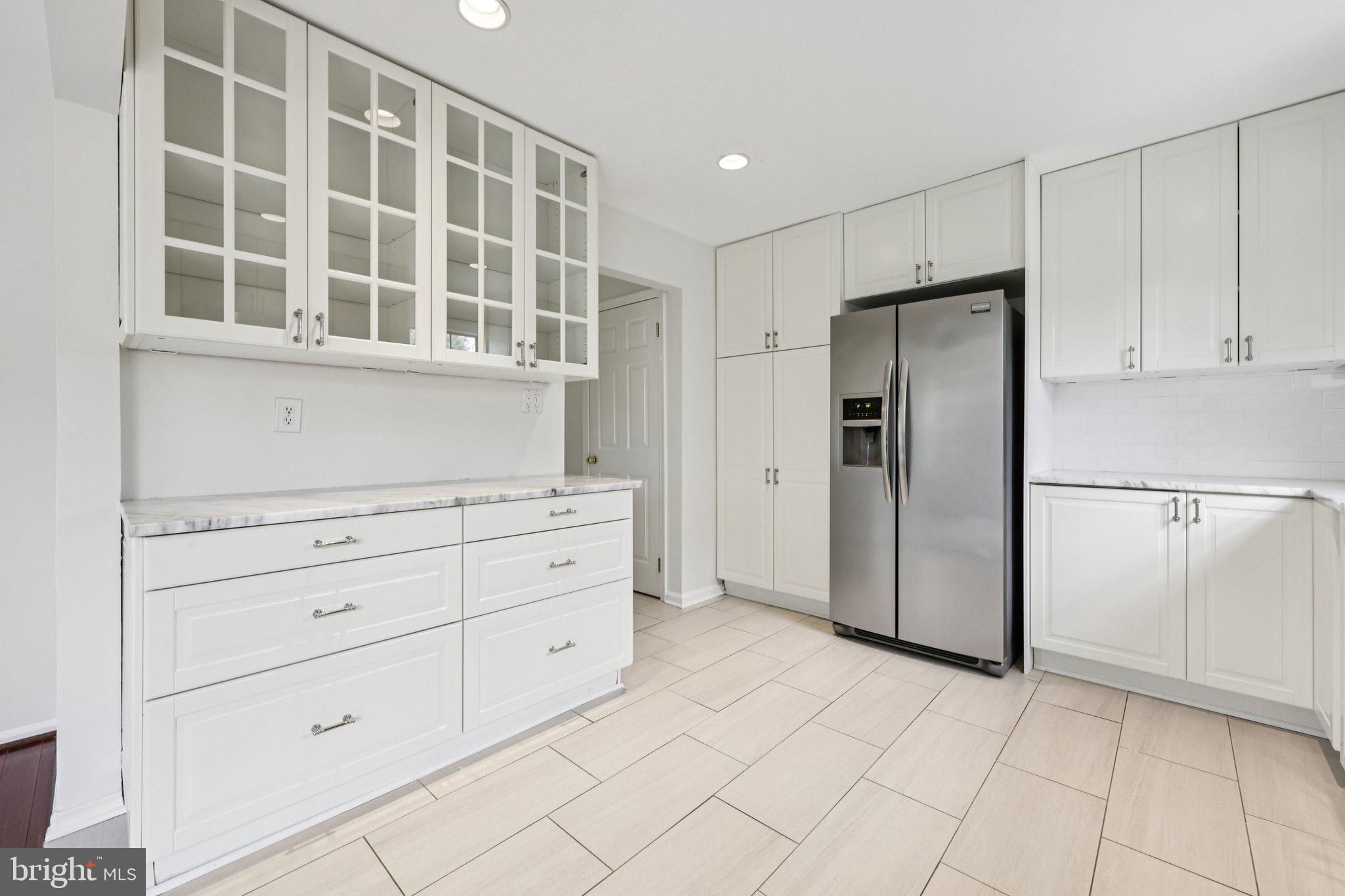 2 Berkeley Court Sterling, VA 20165 - Photo 13 of 46 a kitchen with cabinets and refrigerator