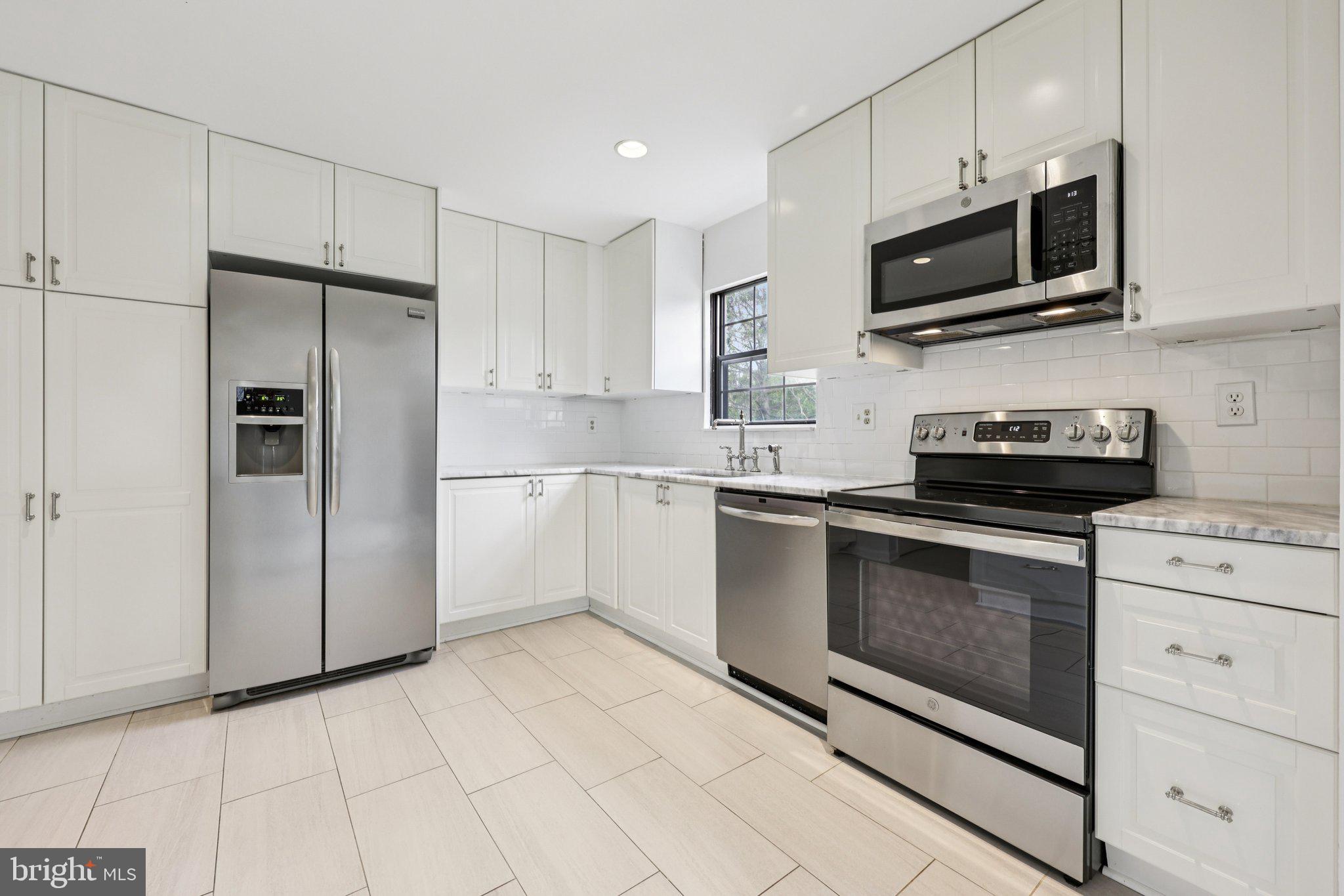 2 Berkeley Court Sterling, VA 20165 - Photo 14 of 46 a kitchen with cabinets stainless steel appliances and counter space