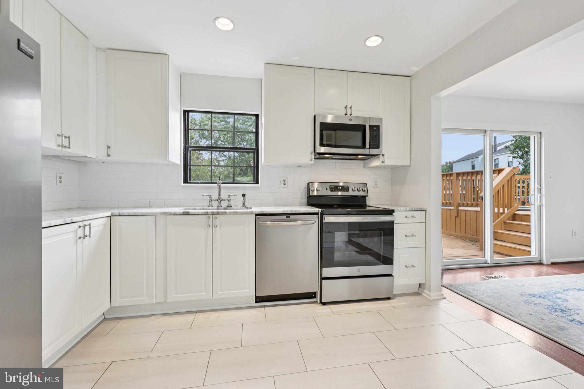 2 Berkeley Court Sterling, VA 20165 - Photo 15 of 46 a kitchen with white cabinets and appliances