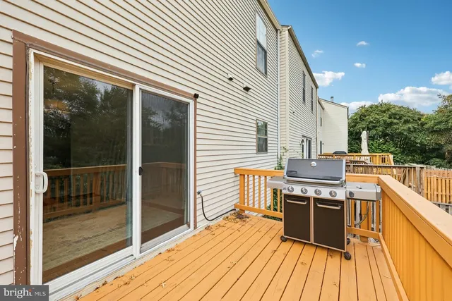 a kitchen view with wooden floor and outdoor space