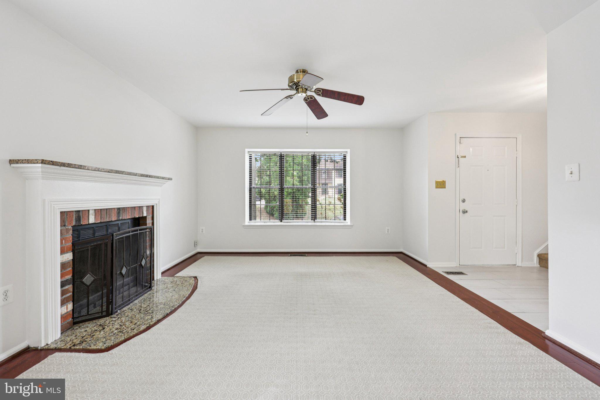 2 Berkeley Court Sterling, VA 20165 - Photo 5 of 46 an empty room with windows and fireplace
