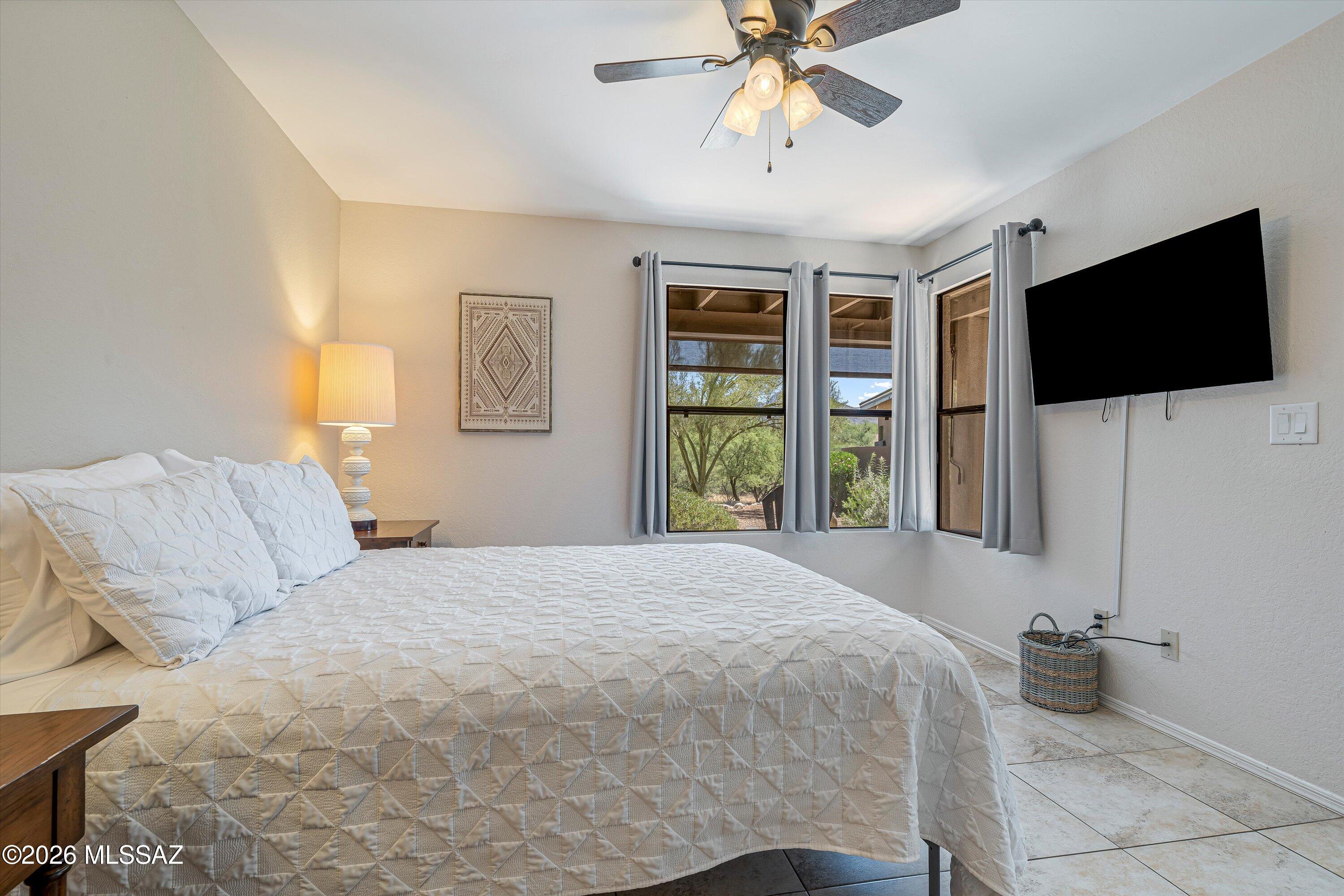 5800 North Kolb Road, Unit 5125 Tucson, AZ 85750 - Photo 14 of 34 a bedroom with a large bed and a flat screen tv