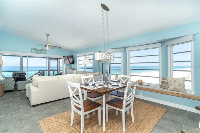 a dining room with furniture a chandelier and wooden floor