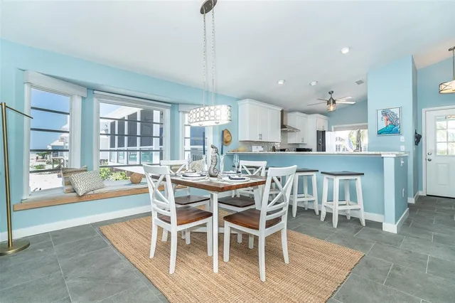 a dining area with a table chairs and a kitchen view