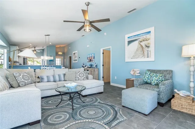 a living room with furniture and a view of kitchen