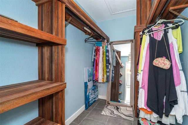a view of walk in closet with clothes