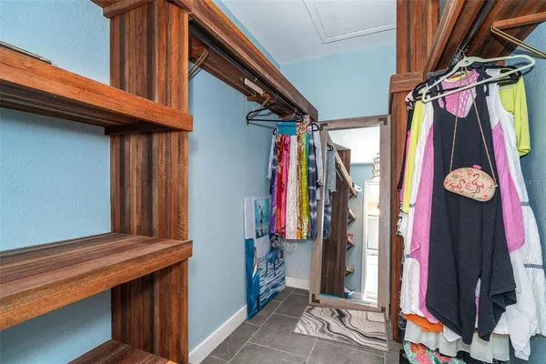 a view of walk in closet with clothes