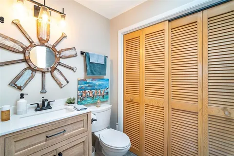 a bathroom with a sink a mirror and a window