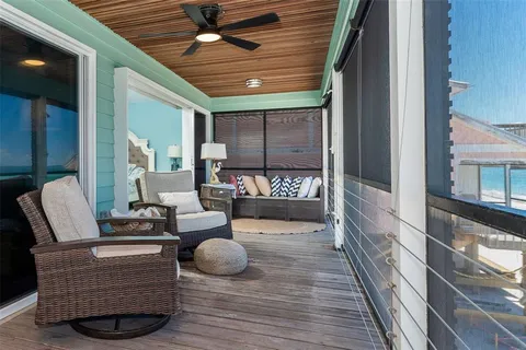 a outdoor space with patio the couches and a dining table with wooden floor