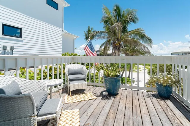 a view of balcony with furniture and potted plants