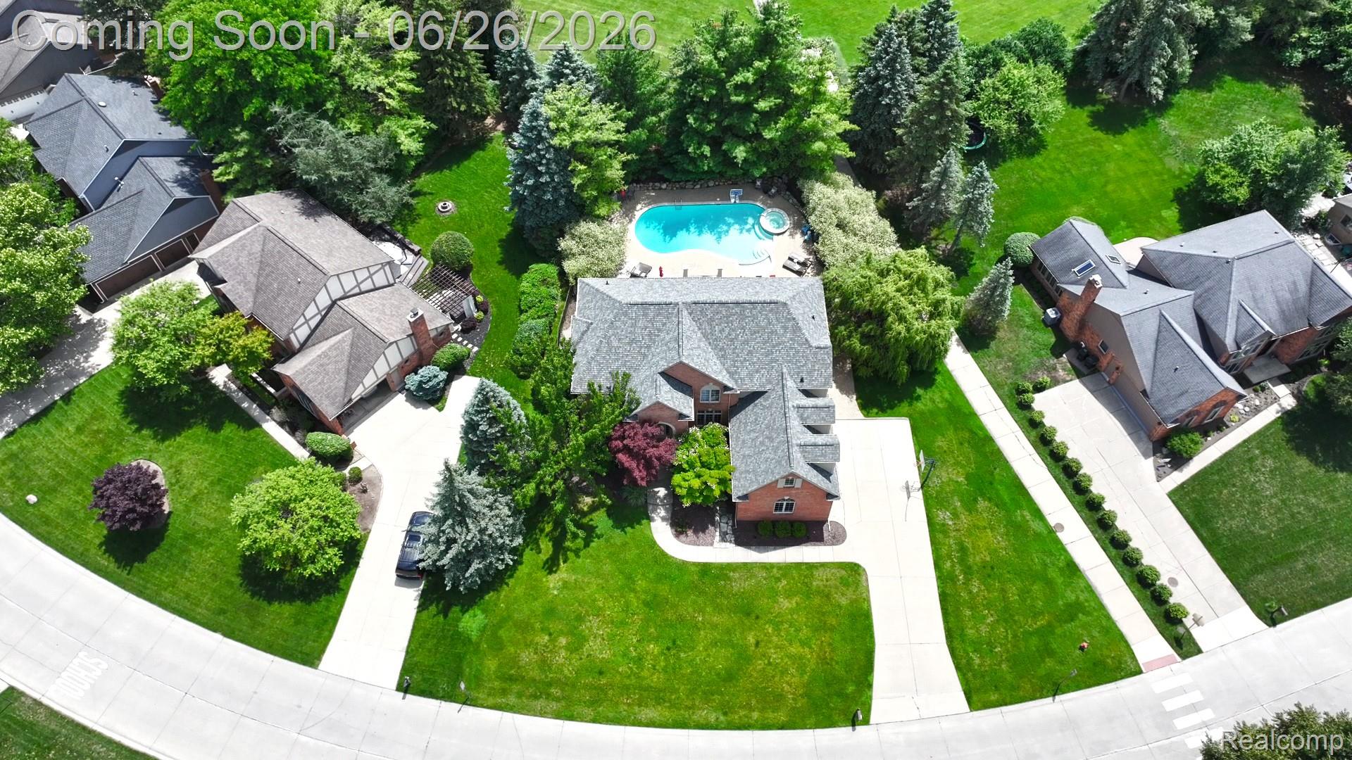 2619 Lambeth Park Rochester, MI 48306 - Photo 56 of 71 Expansive property featuring a central residence, large inground pool, manicured lawns, mature trees, and a concrete driveway