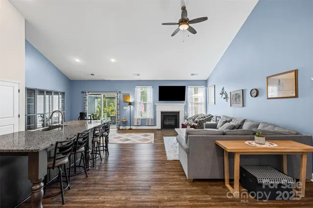 a kitchen with stainless steel appliances granite countertop a refrigerator and a stove top oven