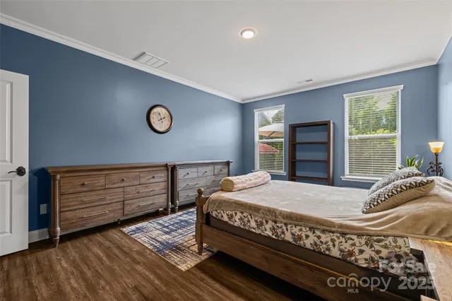 a view of a house with a big yard and large trees
