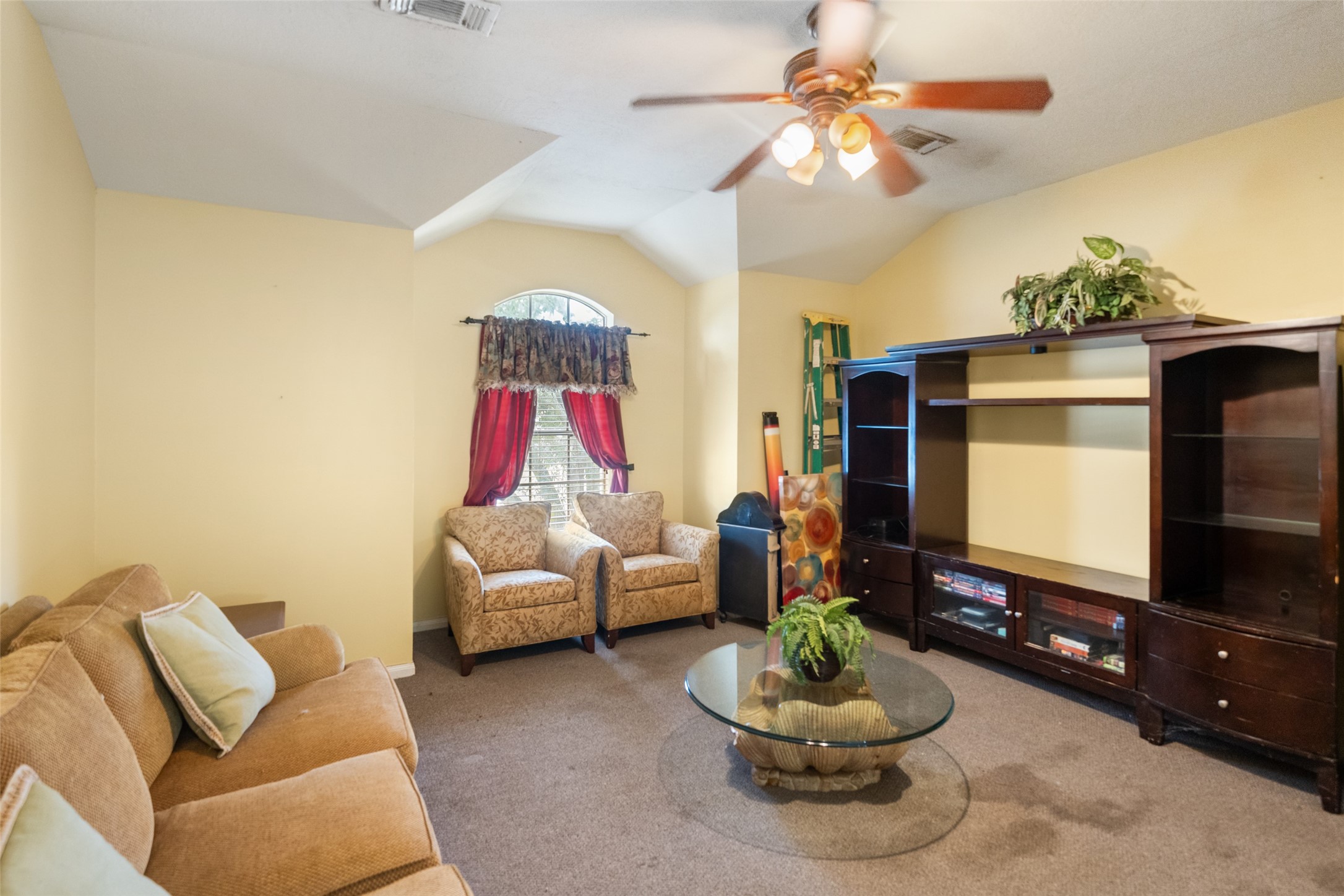2514 Raintree Village Drive Katy, TX 77449 - Photo 13 of 26 a living room with furniture a flat screen tv and a window