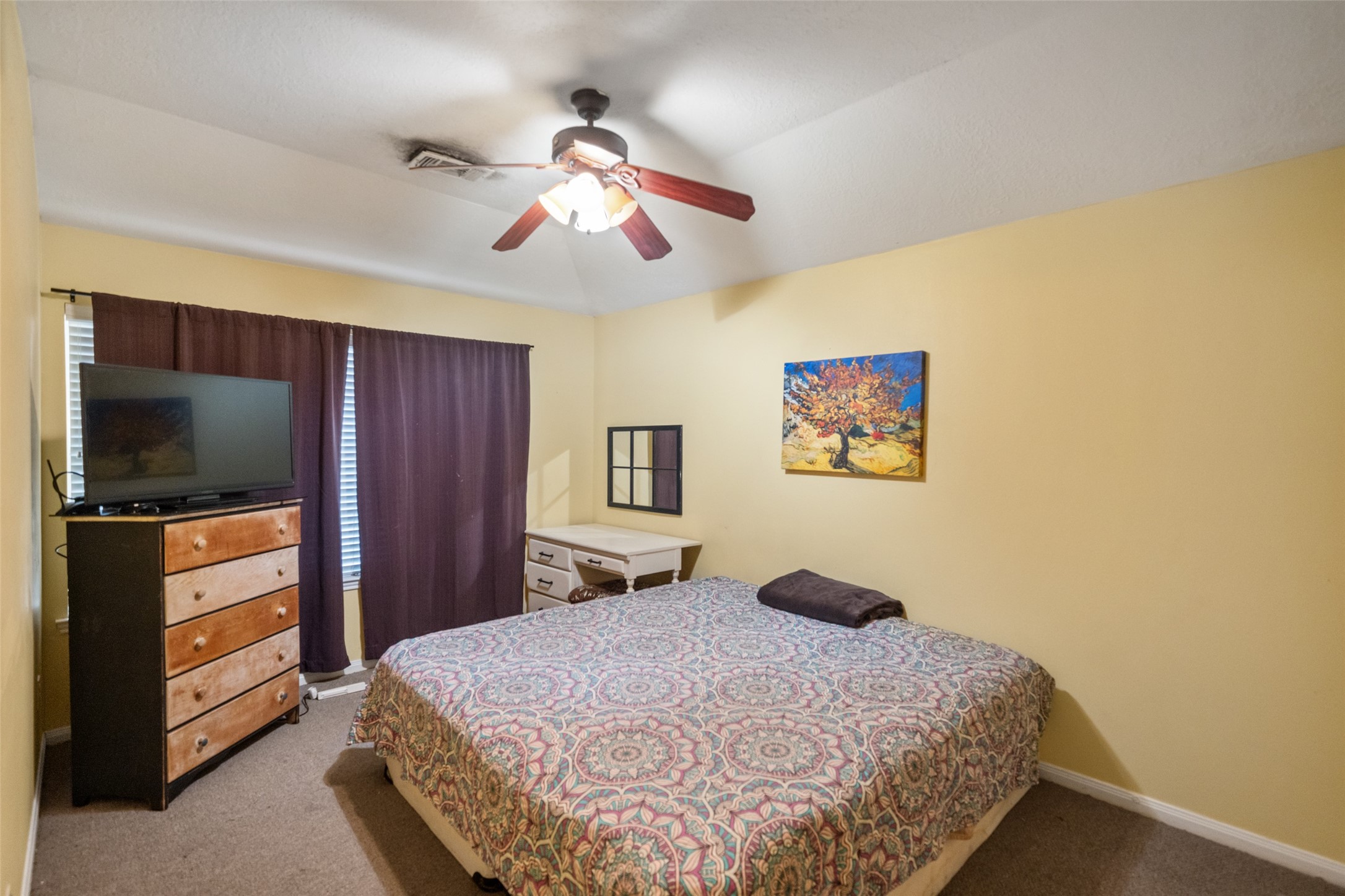 2514 Raintree Village Drive Katy, TX 77449 - Photo 21 of 26 a bedroom with a bed and a flat screen tv