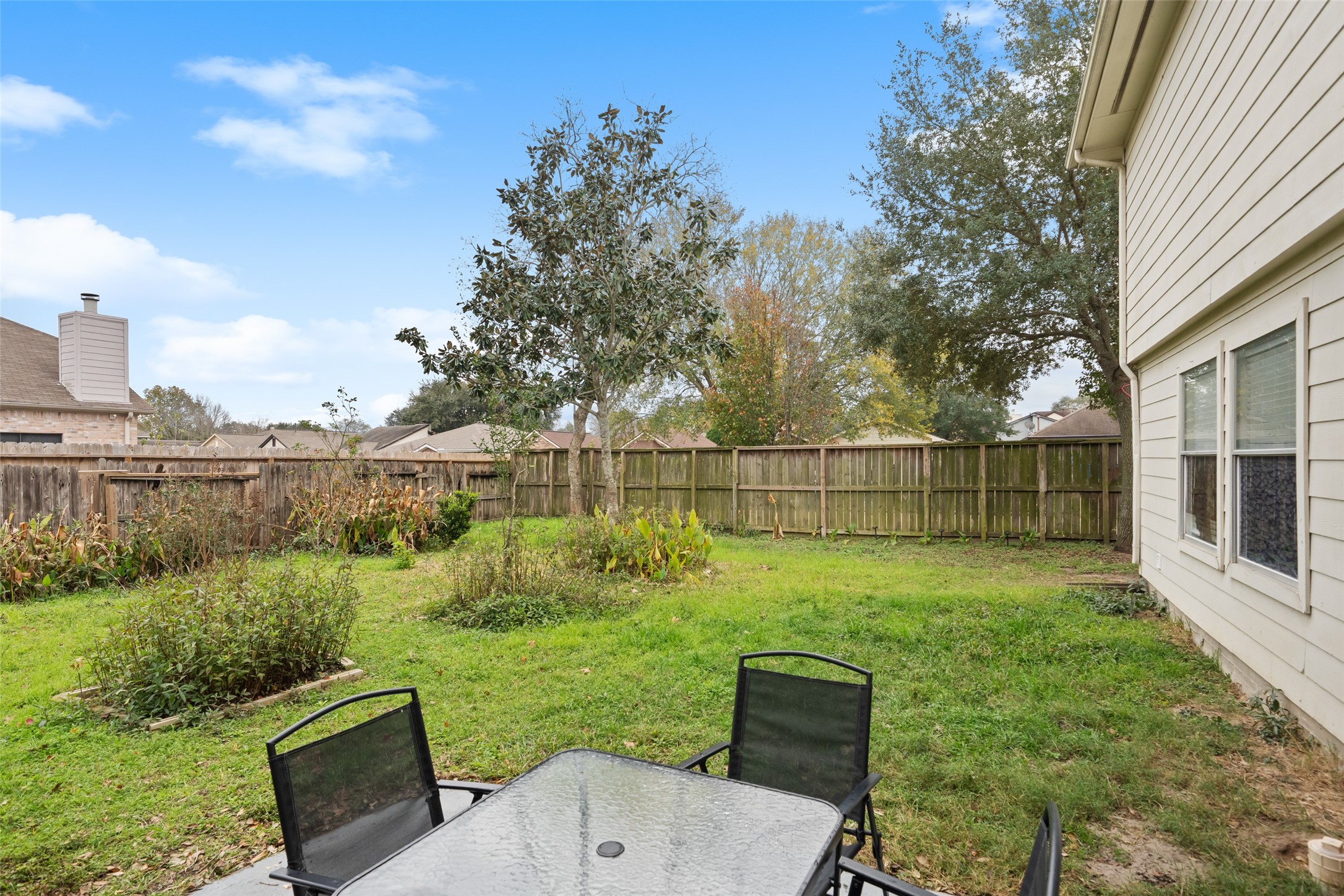 2514 Raintree Village Drive Katy, TX 77449 - Photo 25 of 26 a backyard of a house with table and chairs