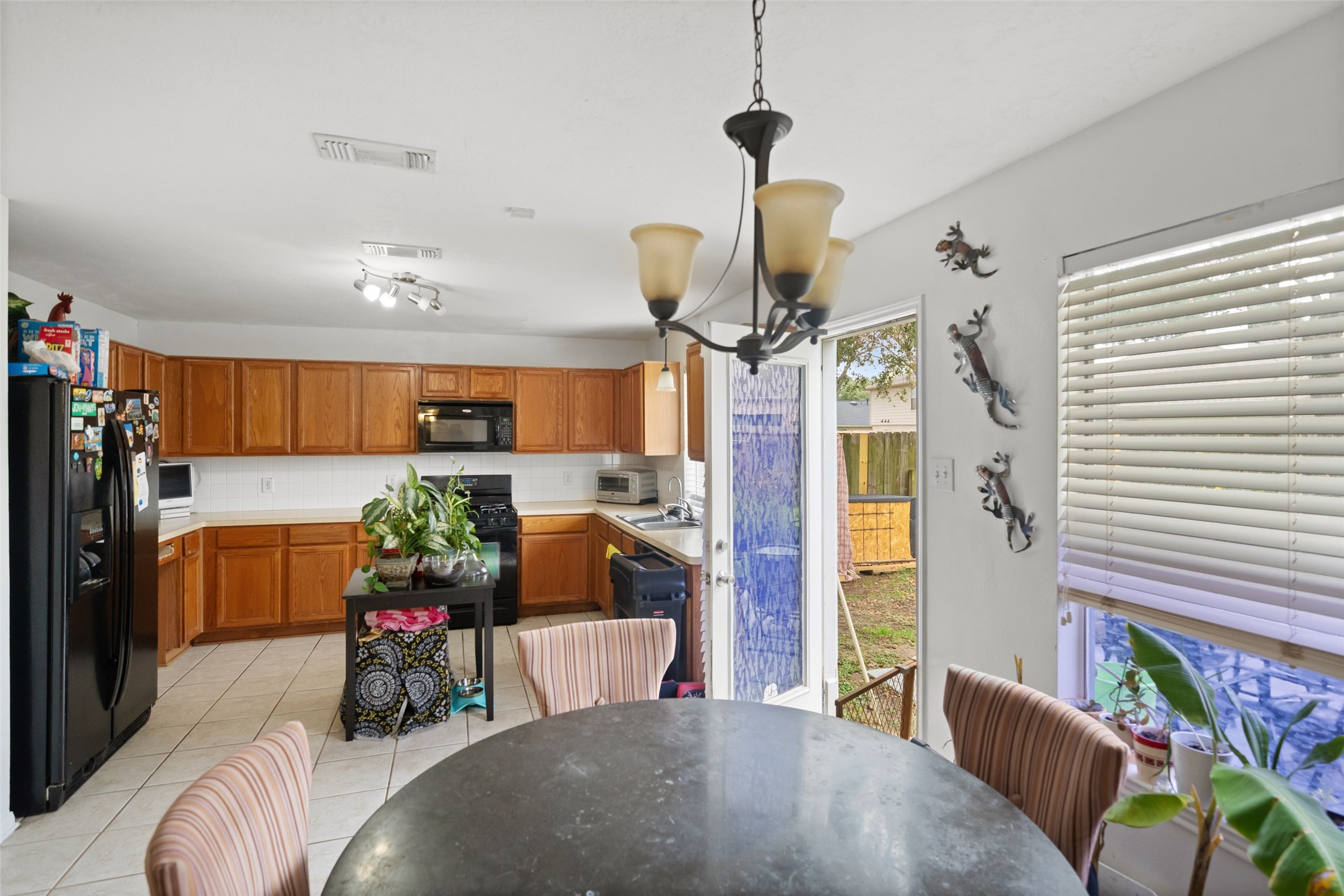 2514 Raintree Village Drive Katy, TX 77449 - Photo 9 of 26 a living room with furniture and a chandelier