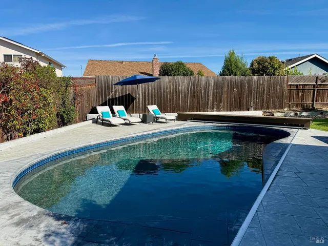 a view of a backyard with sitting area